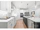 Open kitchen featuring a large island with a stainless steel dishwasher and sink at 9833 Ardley Park Way, Mint Hill, NC 28227
