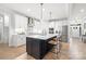 Bright kitchen features a large island, modern white cabinetry, and stainless steel appliances at 9833 Ardley Park Way, Mint Hill, NC 28227