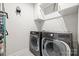 The laundry room features modern appliances and ample storage space at 9833 Ardley Park Way, Mint Hill, NC 28227