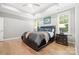 Spacious main bedroom with tray ceiling, ceiling fan, and hardwood flooring at 9833 Ardley Park Way, Mint Hill, NC 28227