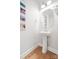 Clean and minimalist powder room with a pedestal sink and modern decor, showcasing functional elegance at 9833 Ardley Park Way, Mint Hill, NC 28227