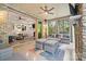 Cozy screened porch with a stone fireplace and comfortable seating, perfect for outdoor relaxation at 9833 Ardley Park Way, Mint Hill, NC 28227