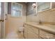 Well-lit bathroom with decorative wallpaper and a sink with storage cabinets at 1010 Forest Dr, Lancaster, SC 29720