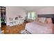 Charming pink bedroom featuring hardwood floors, natural light, and vaulted ceilings at 1010 Forest Dr, Lancaster, SC 29720