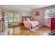 Charming pink bedroom featuring hardwood floors, natural light, and vaulted ceilings at 1010 Forest Dr, Lancaster, SC 29720