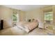 Bright bedroom with large windows, neutral tones, and side tables at 1010 Forest Dr, Lancaster, SC 29720