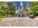 Attached carport and large parking area provide ample space on a sunny day at 1010 Forest Dr, Lancaster, SC 29720
