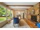 Bright dining room featuring exposed beam ceilings and brick fireplace, filled with natural light at 1010 Forest Dr, Lancaster, SC 29720