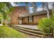 Charming brick home featuring a spacious wooden deck perfect for outdoor entertaining and enjoyment at 1010 Forest Dr, Lancaster, SC 29720