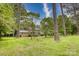 Charming two-story brick home surrounded by mature trees and lush green lawn on a sunny day at 1010 Forest Dr, Lancaster, SC 29720