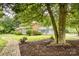 Charming brick home with a well-manicured lawn, framed by mature trees and mulch beds at 1010 Forest Dr, Lancaster, SC 29720