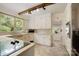 Bright kitchen features white cabinets, plenty of natural light, and updated appliances at 1010 Forest Dr, Lancaster, SC 29720