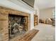 Living room showcases brick fireplace, neutral carpet, and plenty of natural light at 1010 Forest Dr, Lancaster, SC 29720