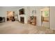 Cozy living room features neutral carpet, fireplace, and views into other rooms at 1010 Forest Dr, Lancaster, SC 29720