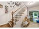 Staircase with bright lighting, wood steps, white painted risers, and a view into the next room at 1010 Forest Dr, Lancaster, SC 29720