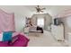 Cozy bedroom with pink accents, sloped ceilings, and a ceiling fan at 1032 Seminole Dr, Waxhaw, NC 28173