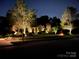 Inviting home with expertly lit mature trees and manicured landscaping at 1032 Seminole Dr, Waxhaw, NC 28173