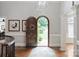 Elegant foyer featuring a decorative arched front door, hardwood floors, and stylish decor at 1032 Seminole Dr, Waxhaw, NC 28173