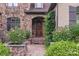 Charming entryway with a decorative front door, stone steps, and lush greenery at 1032 Seminole Dr, Waxhaw, NC 28173
