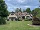 Elegant home featuring a stone facade, manicured lawn, and verdant landscaping at 1032 Seminole Dr, Waxhaw, NC 28173