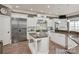 Bright kitchen features white cabinets, a large center island, stainless steel appliances, and granite countertops at 1032 Seminole Dr, Waxhaw, NC 28173