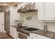 Chef's kitchen with stainless steel appliances, white cabinets, and granite countertops at 1032 Seminole Dr, Waxhaw, NC 28173