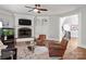 Spacious living room with fireplace, custom cabinets, ceiling fan, and hardwood floors at 1032 Seminole Dr, Waxhaw, NC 28173