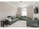 Bright living room features three green sofas, a cat tree, and a large window at 1032 Seminole Dr, Waxhaw, NC 28173