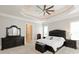 Spacious bedroom with a black leather bed frame, ceiling fan, and a walk-in closet at 1032 Seminole Dr, Waxhaw, NC 28173