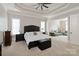 Spacious bedroom featuring a sitting area, large windows, and a tray ceiling at 1032 Seminole Dr, Waxhaw, NC 28173
