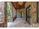Stone patio with a wood ceiling, pillars, and ceiling fan at 1032 Seminole Dr, Waxhaw, NC 28173