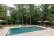 Resort style pool area with hot tub, lush landscaping, and outdoor seating perfect for entertaining at 1032 Seminole Dr, Waxhaw, NC 28173