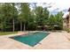 Beautiful backyard oasis featuring a sparkling pool, travertine decking, and lush greenery at 1032 Seminole Dr, Waxhaw, NC 28173