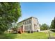 Beautiful backyard featuring a large lawn, wooden deck with stairs, mature trees, and ample sunlight at 11103 Fountaingrove Dr, Charlotte, NC 28262