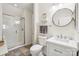 Modern bathroom featuring a glass-enclosed shower and sleek vanity with a round mirror at 11103 Fountaingrove Dr, Charlotte, NC 28262