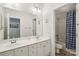 Well-lit bathroom featuring double sinks, large mirror, and a shower with blue curtain at 11103 Fountaingrove Dr, Charlotte, NC 28262