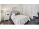 Cozy bedroom featuring neutral walls, a plush bed with patterned pillows, and a matching nightstand at 11103 Fountaingrove Dr, Charlotte, NC 28262
