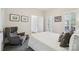 Relaxing bedroom featuring neutral decor, a comfortable gray armchair, and bright natural light at 11103 Fountaingrove Dr, Charlotte, NC 28262