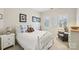 Comfortable bedroom featuring a white bed with blue accents, a cozy chair, and bright natural light at 11103 Fountaingrove Dr, Charlotte, NC 28262