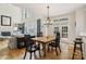 Dining area adjacent to the living room featuring hardwood floors and a view of the deck through French doors at 11103 Fountaingrove Dr, Charlotte, NC 28262