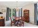 Elegant dining room with bay window, chandelier, and classic wood furniture at 11103 Fountaingrove Dr, Charlotte, NC 28262