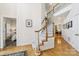 Bright foyer featuring hardwood floors, staircase, and views into adjacent dining and living spaces at 11103 Fountaingrove Dr, Charlotte, NC 28262