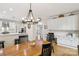 Open kitchen and breakfast nook boast hardwood floors and modern lighting fixtures at 11103 Fountaingrove Dr, Charlotte, NC 28262