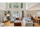 Open-concept living room with high ceilings, large windows, hardwood floors, and stylish furniture at 11103 Fountaingrove Dr, Charlotte, NC 28262
