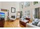 Bright and airy living room with a fireplace, built-in shelving, and large windows for natural light at 11103 Fountaingrove Dr, Charlotte, NC 28262
