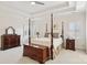 Spacious main bedroom with tray ceiling, four-poster bed, and dual windows at 11103 Fountaingrove Dr, Charlotte, NC 28262