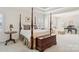 Spacious main bedroom featuring a four-poster bed, wood floors, and sitting area at 11103 Fountaingrove Dr, Charlotte, NC 28262