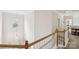 Bright staircase with wood railing and white banisters providing access to the second floor at 11103 Fountaingrove Dr, Charlotte, NC 28262