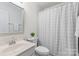Cozy bathroom with a vanity, mirror, and a shower-tub combo with a patterned curtain at 1123 Market St, Fort Mill, SC 29708
