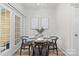 Dining area with a glass table, modern chairs, and doors leading to an outdoor space at 1123 Market St, Fort Mill, SC 29708